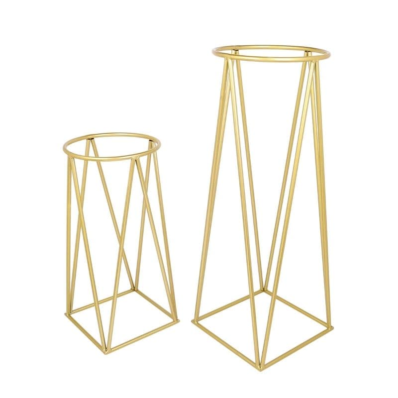 Pair of empty geometric gold metal plant stands at two heights, on white.